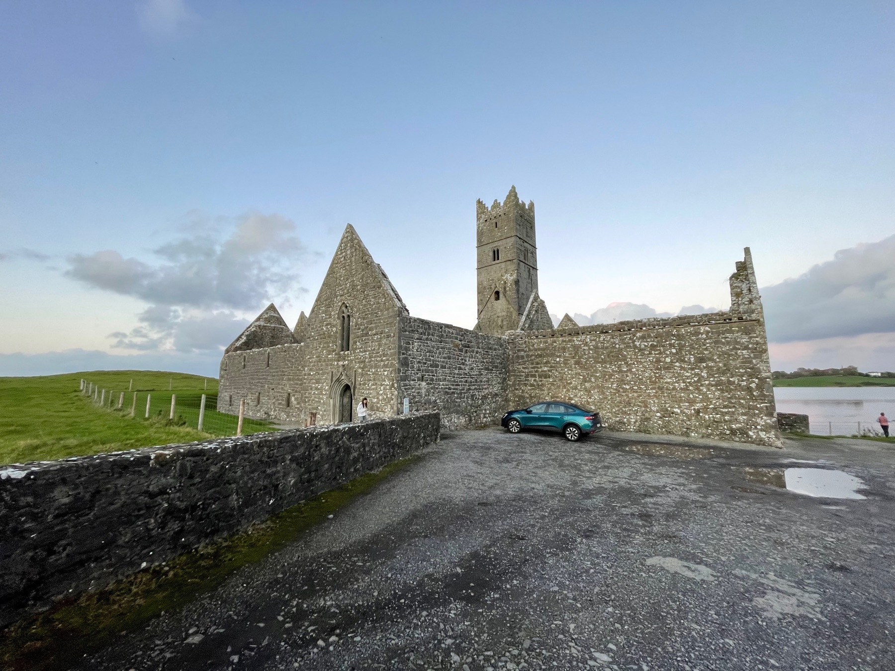 Rosserk Friary from the south, bell tower and precinct wall, River Moy beyond